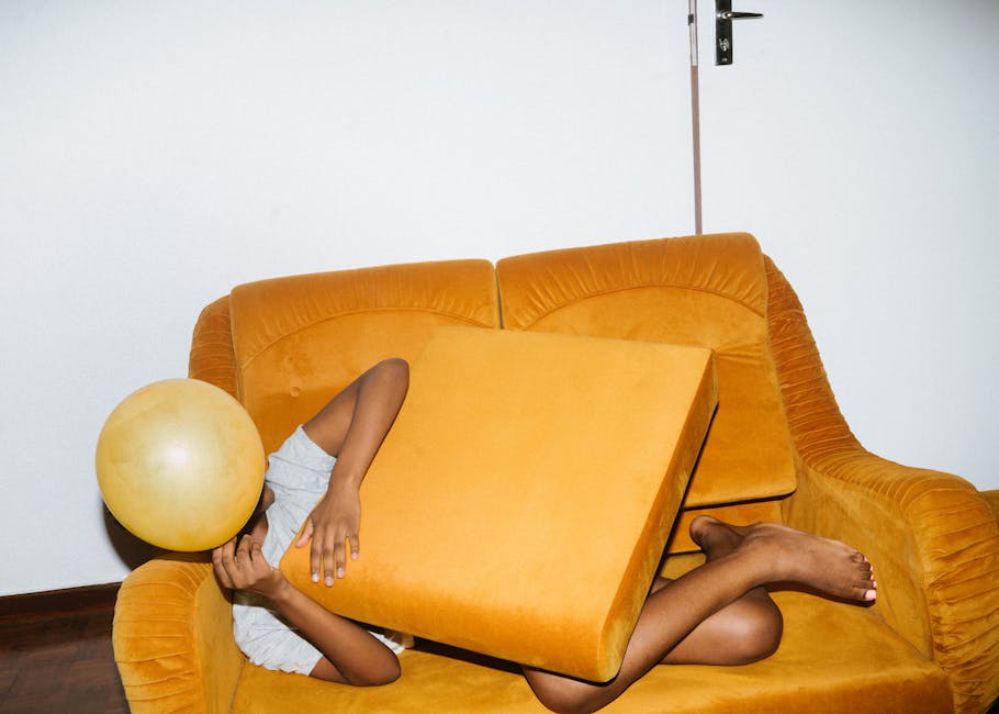 Person in comfortable clothes meditating at home in a bright living room